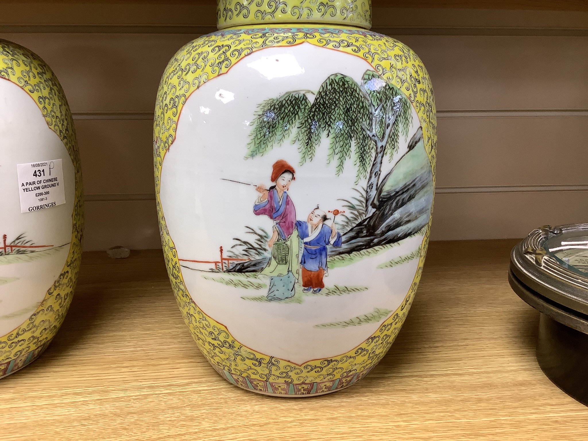 A pair of Chinese yellow ground vases and covers, height 30cm